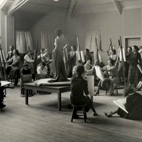 vintage black and white- naked woman pose in front of group of art students