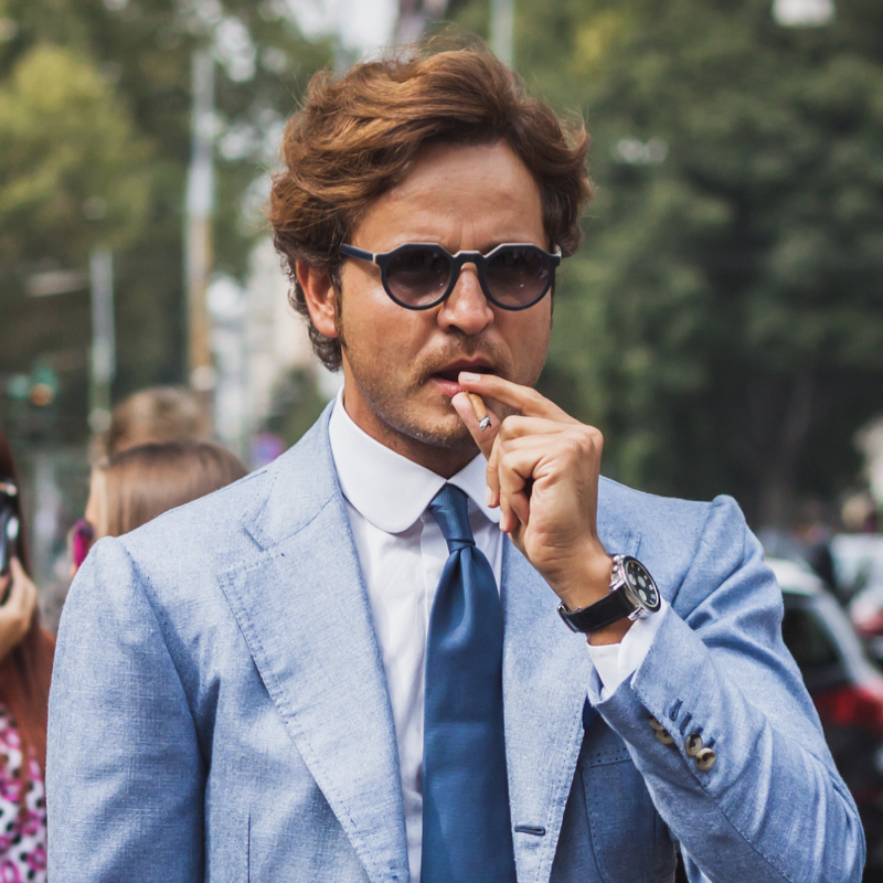 Man wearing a suit and watch.