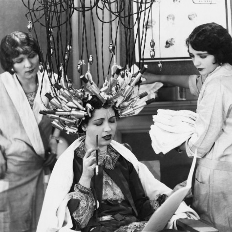 vintage black and white photo with a woman doing a crazy treatment in the hairdresser