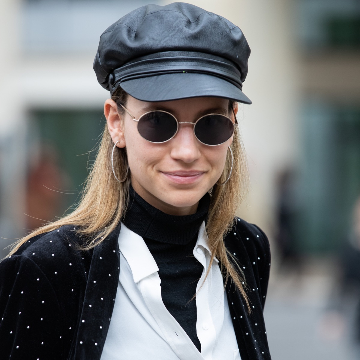 fashionista during fashion week wearing a black turtleneck paired with a white shirt.