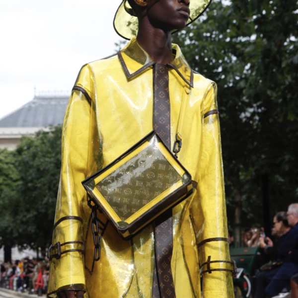 Model presenting a yellow Louis Vuitton raincoat, hat and bag for spring 2020.