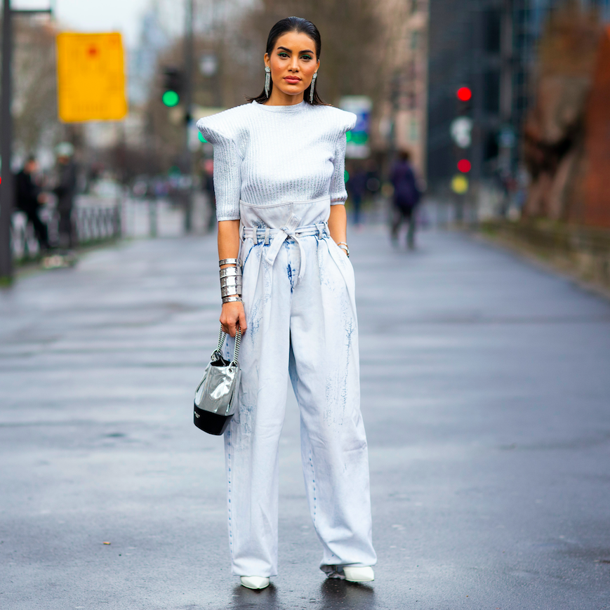 Influencer wearing light blue blouse and paper bag waist pants.