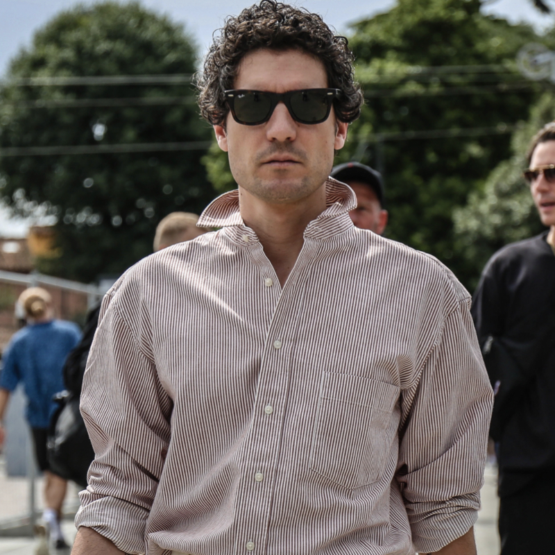 Man wearing oversized Oxford shirt and shades at Pitti Uomo in Florence, Italy.