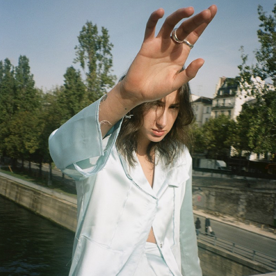 Woman in a park wearing a baby blue satin set