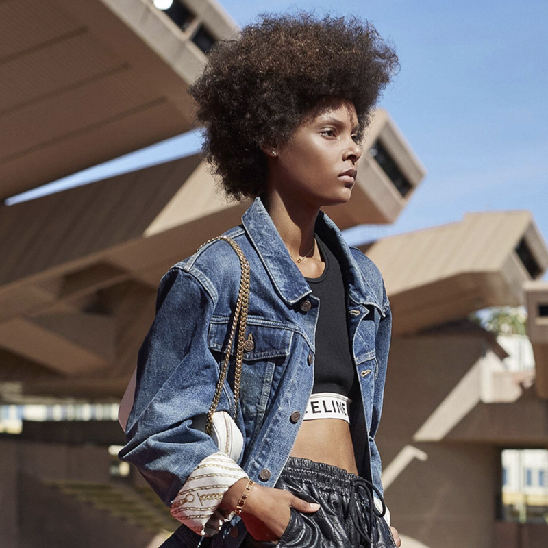 Model wearing exposed bra under denim jacket, one of the spring trends from Milan Fashion Week.