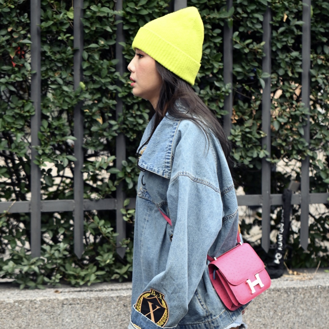 Woman wearing oversized turtleneck and jacket from boyfriend's wardrobe.