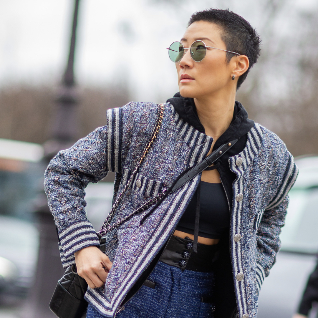 Fashionista wearing gym clothes with Chanel jacket, a athleisure trend in 2021.