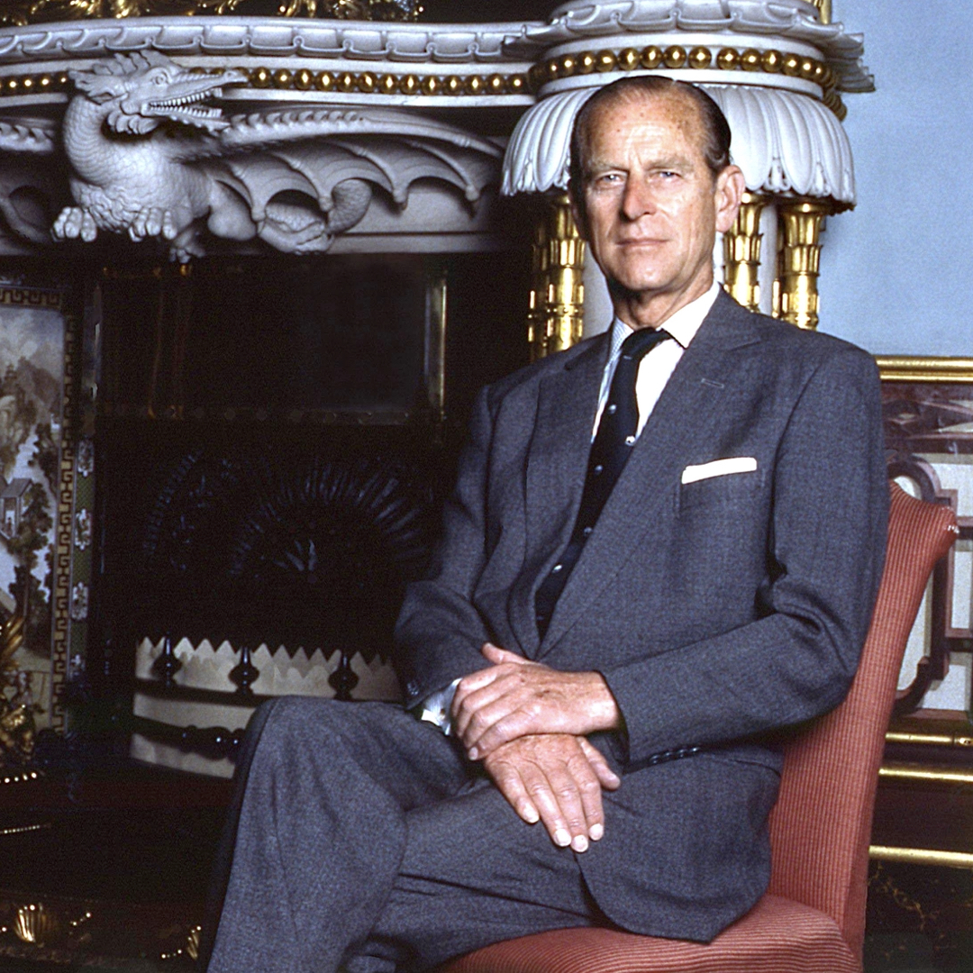 showing Duke of edinburg_style sitting on a chair in front at a fireplace