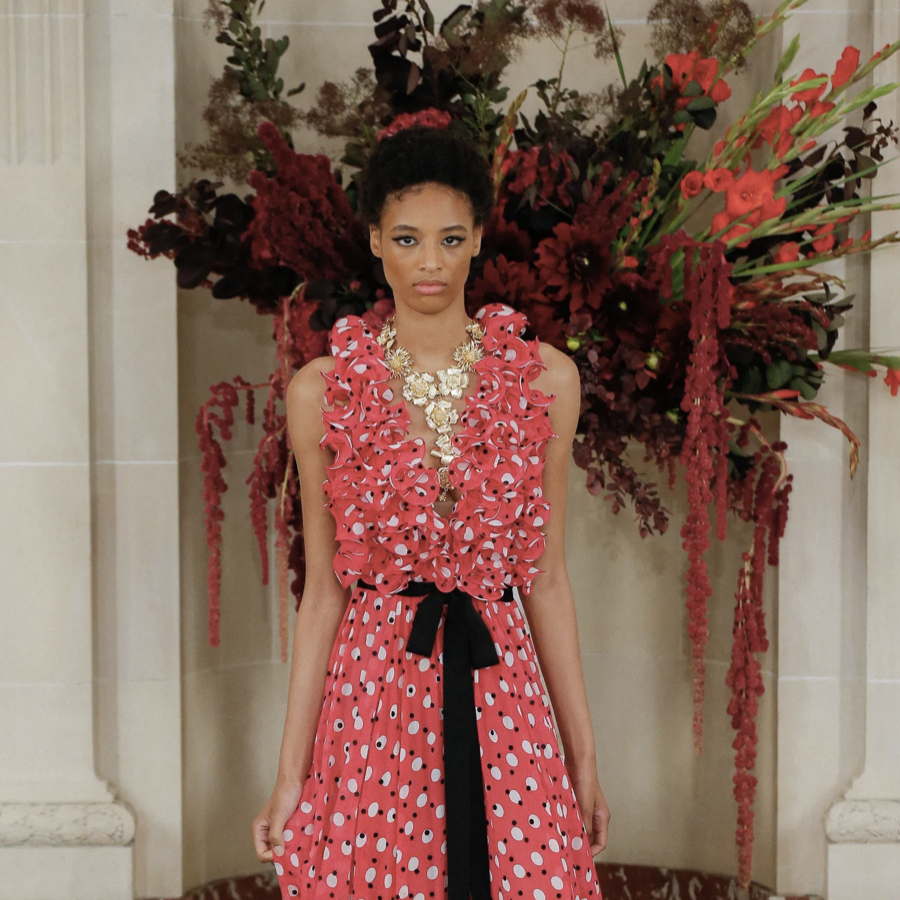 Woman wearing a Carolina Herrera dress with frills and polka dots.