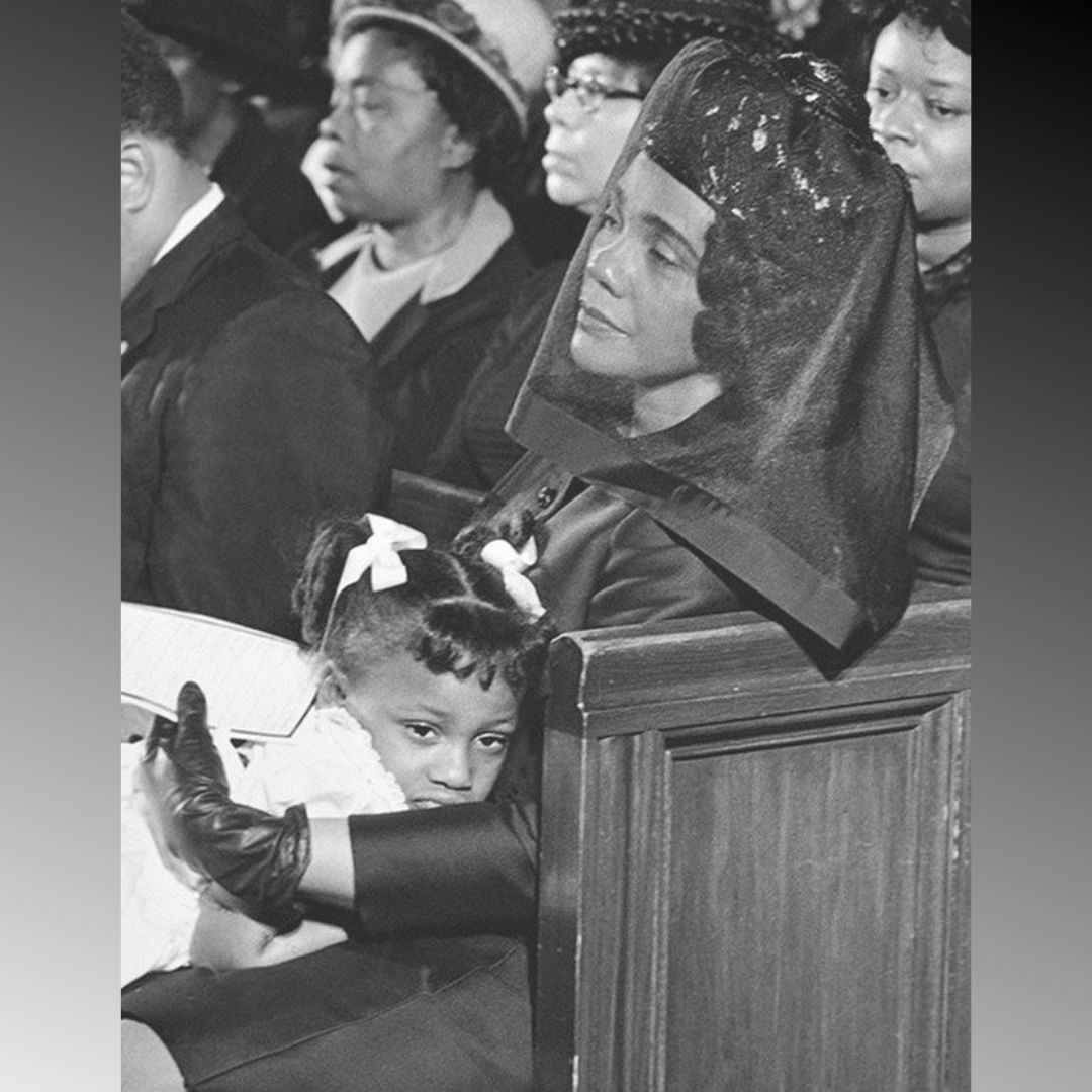 Coretta Scott King at the funeral of Martin Luther King, comforting their 5-year-old daughter, Bernice