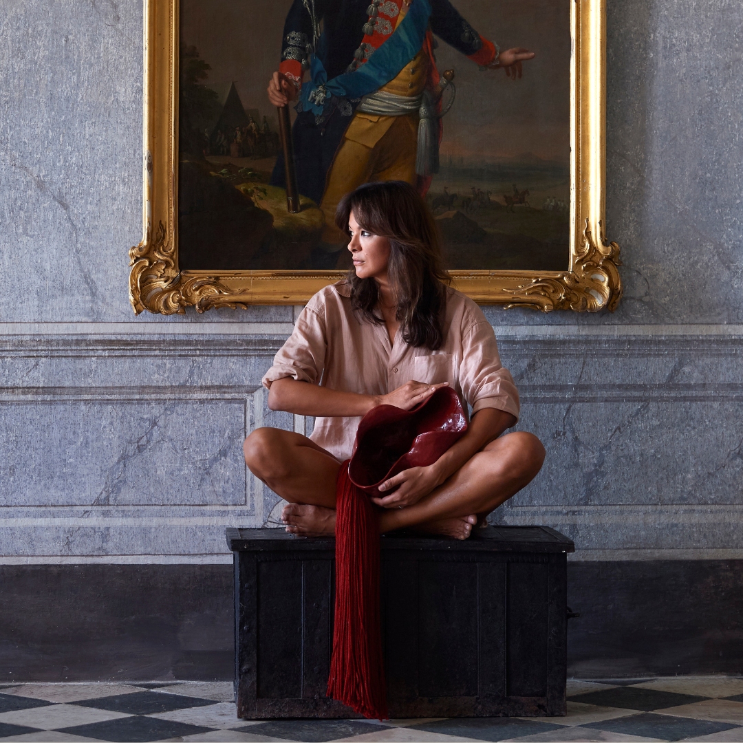 Artist Magda von Hanau holding a sculpture from her Visceral series at Meiselberg castle in Austria during an art exhibition and instalation event.