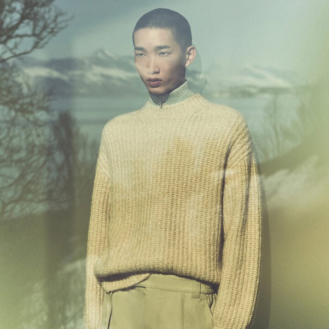 Loro Piana model wearing a neutral colour winter outfit looking through the window to the mountains in Zermatt