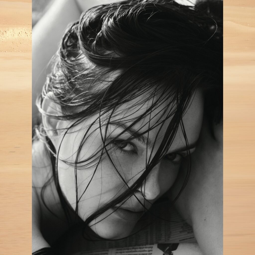 black and white closeup of a model with wet hair on the beach