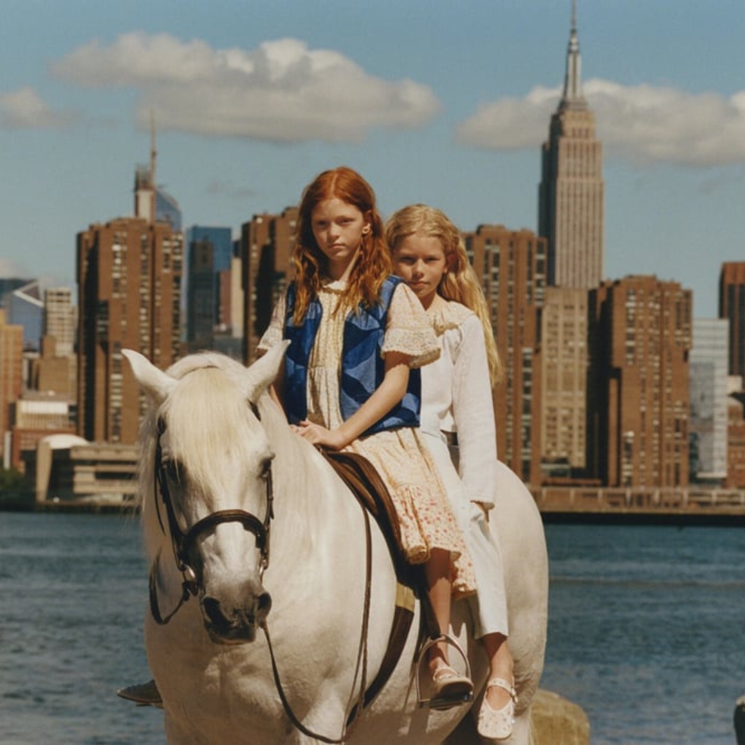 two girls, on a horse, wearing Zara and Sea Children collection and in the background we see Manhattan's skyline