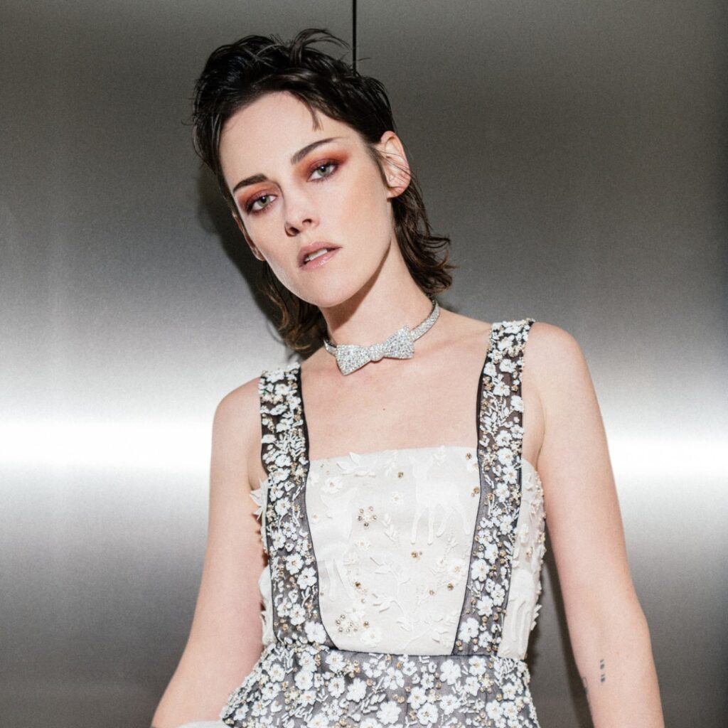 Kristen Stewart at Berlinale 23 wearing a Chanel dress and Chanel beauty while rocking a mod hairstyle