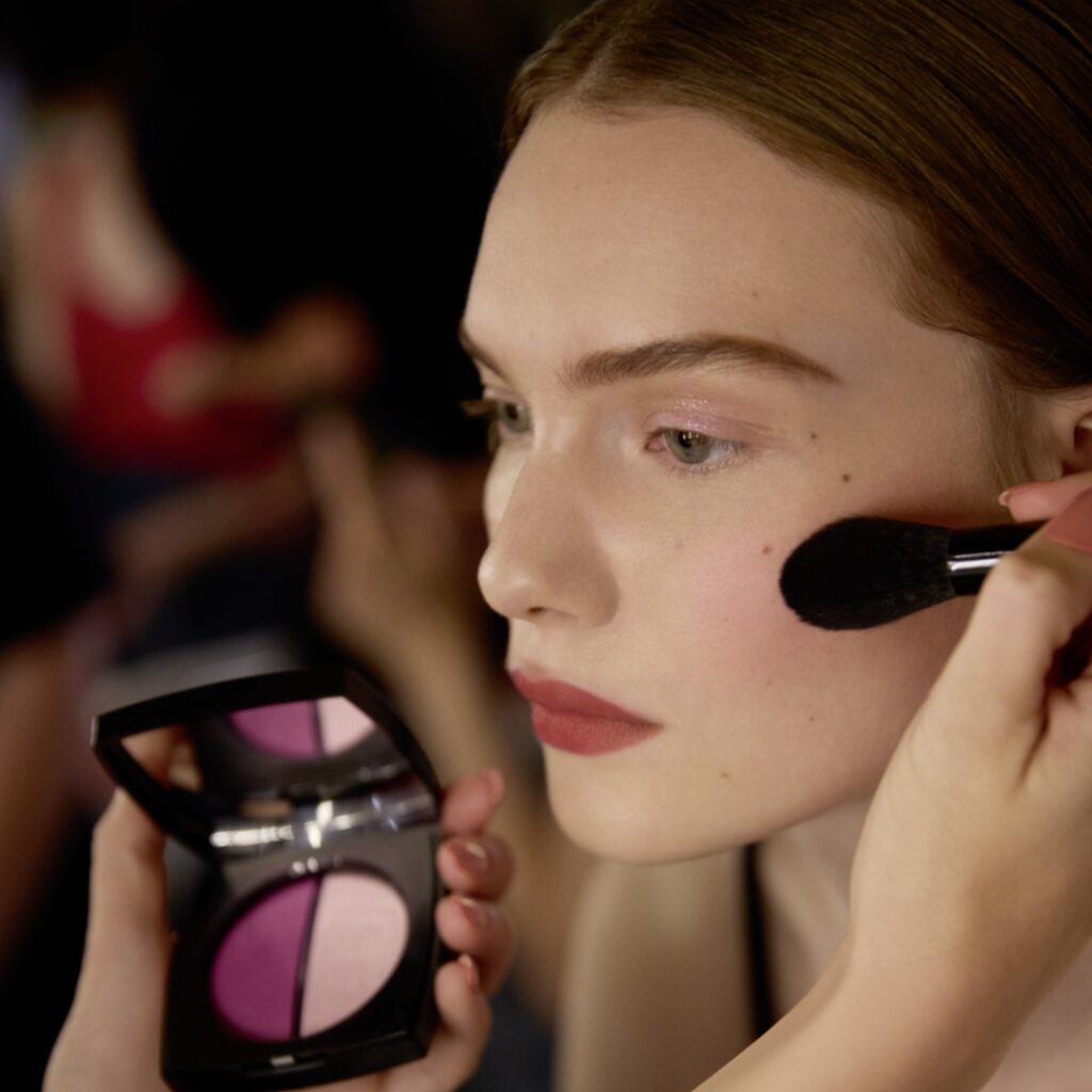 chanel model finishes her makeup at the backstage of the AW24 runway