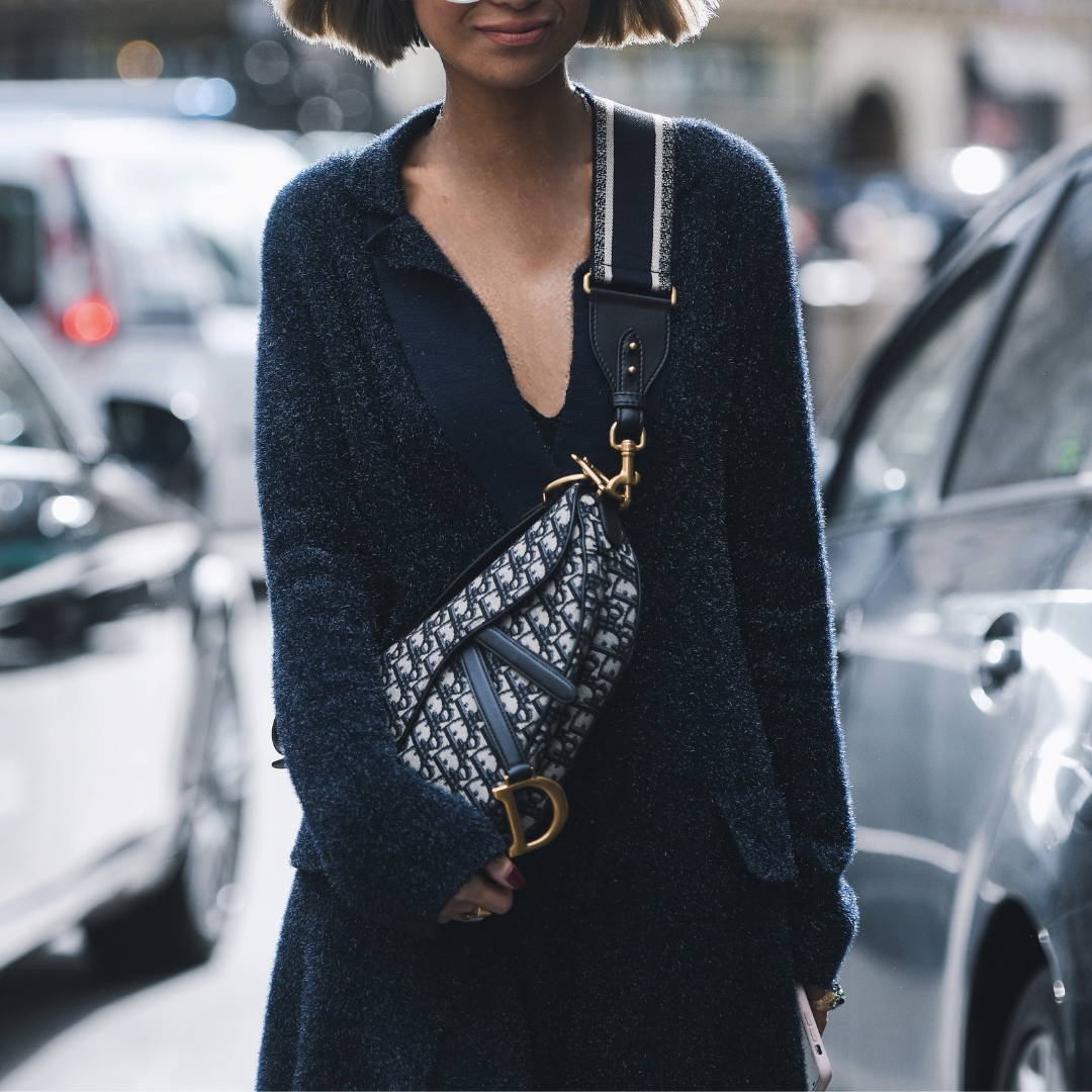 fashionista in paris fashion week, wearing a dior canva bag