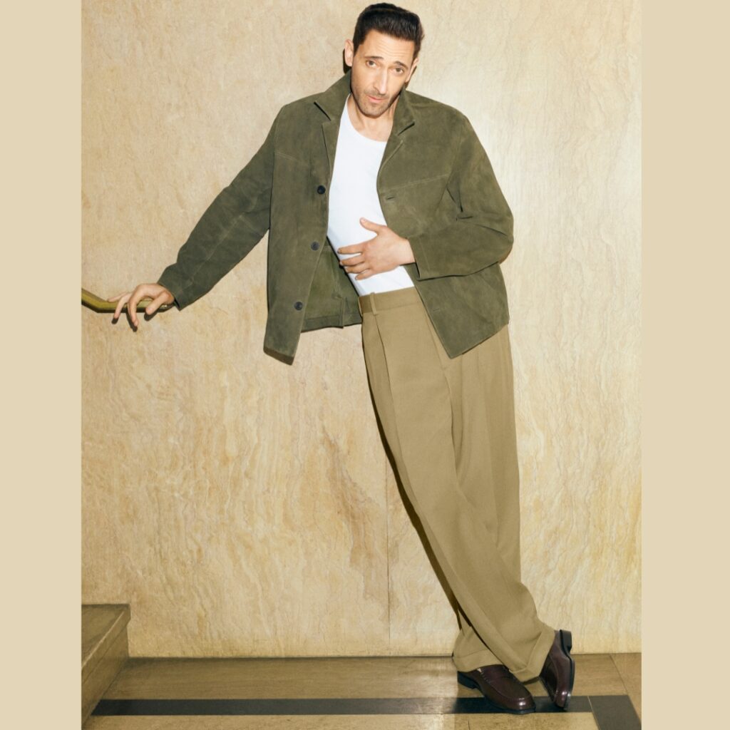 Adrien Brody wearing a moss suede jacket and a khaki pants from COS SS25 collection