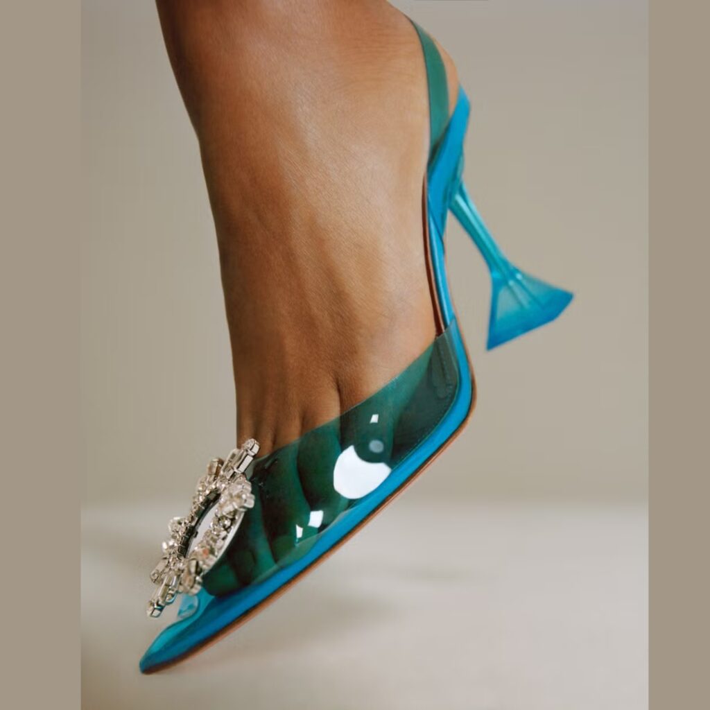 Amina Muaddi iconic bejewelled pump with flared heels