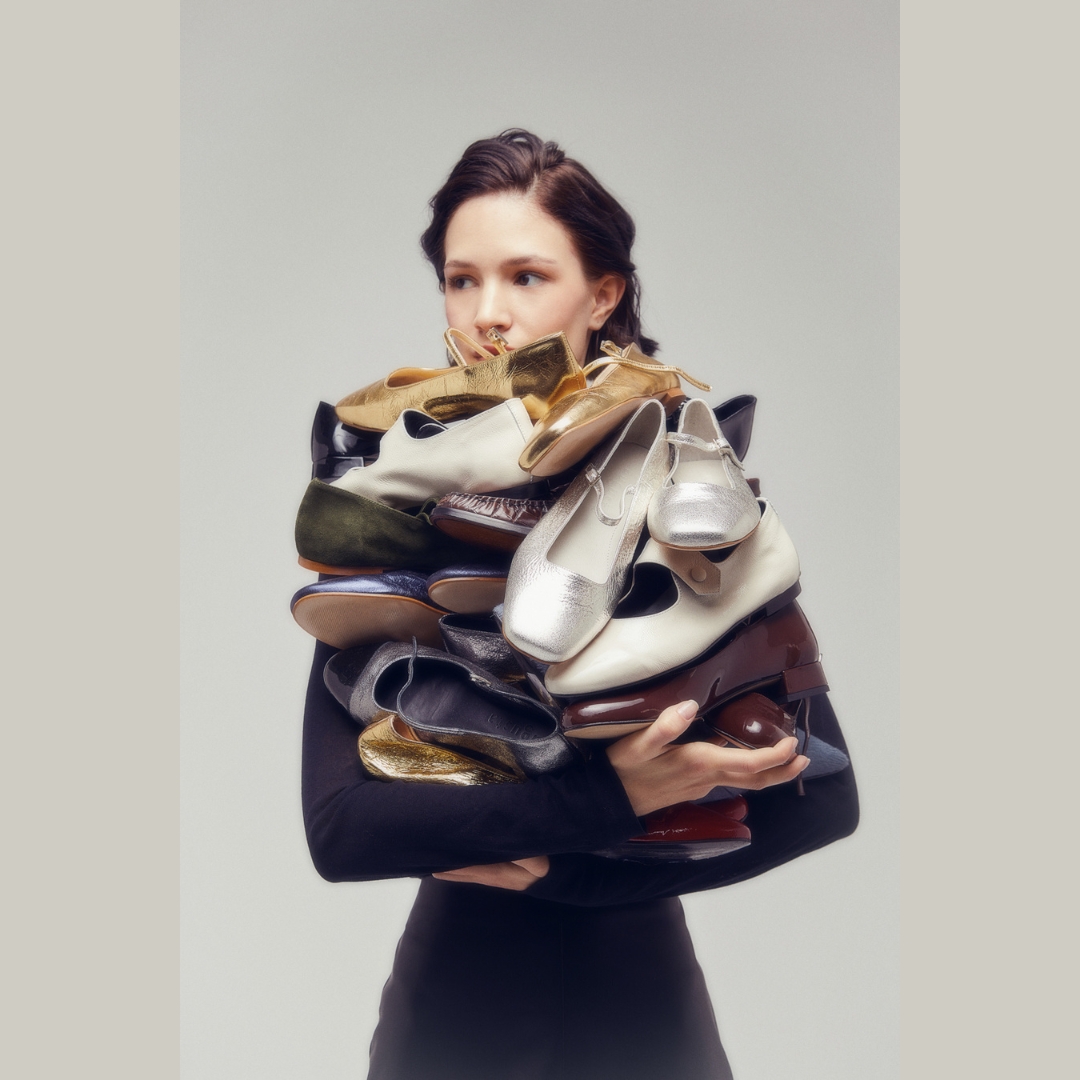 Model carrying a pile of shoes- Augusta shoe brand