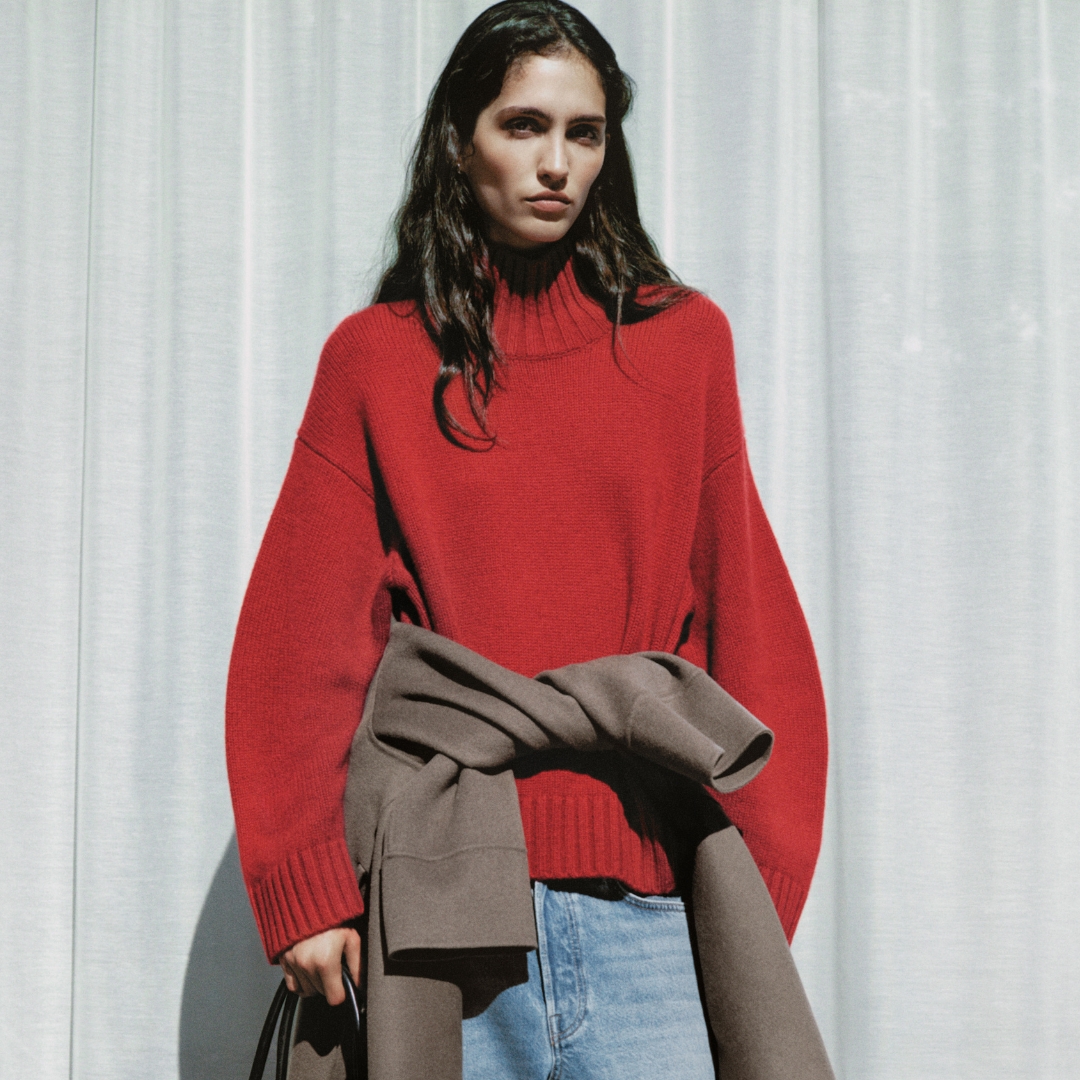 COS model wearing a chunky red cashmere pullover from the AW26 collection