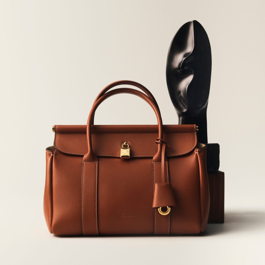 Loom bag from Loro Piana photographed by Charles Negre with wood sculpture by Alexandre Noll 