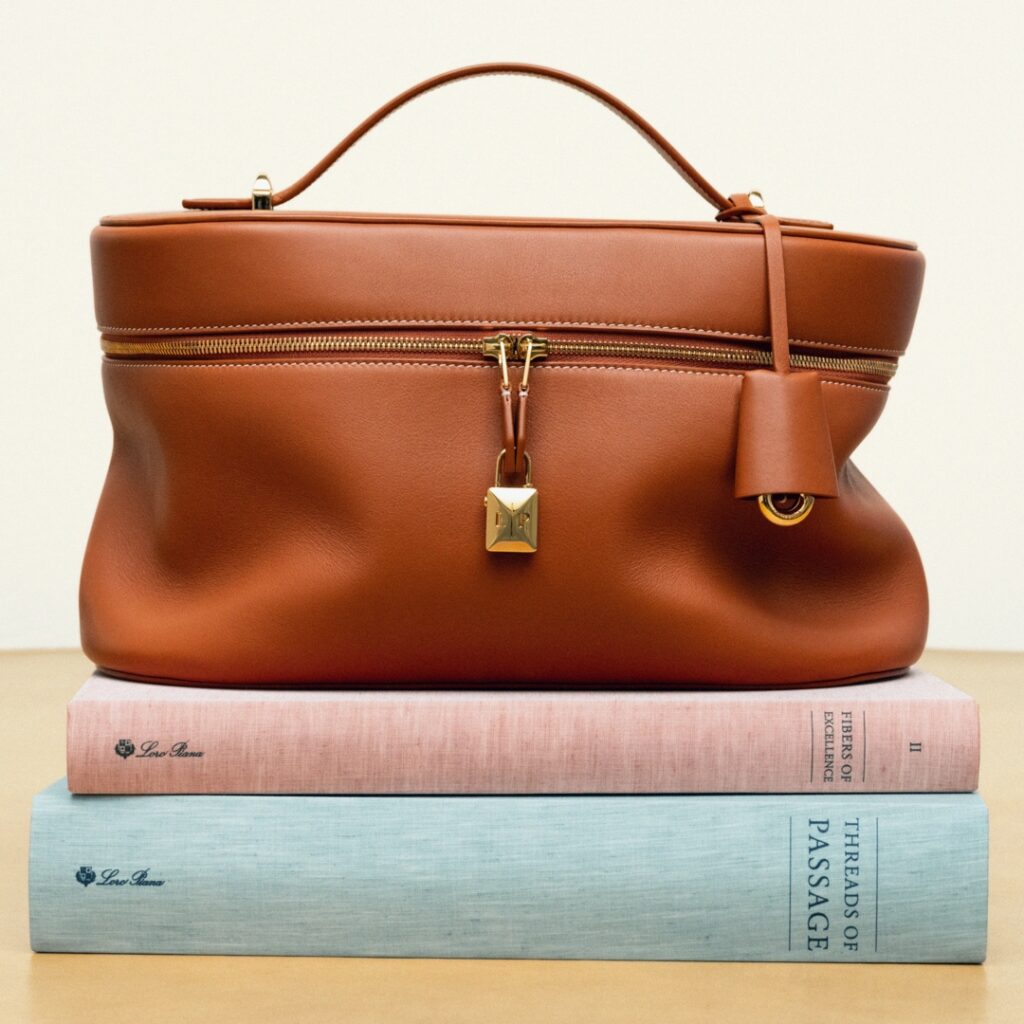 Extra Soft bag from Loro Piana photographed over a pile of books