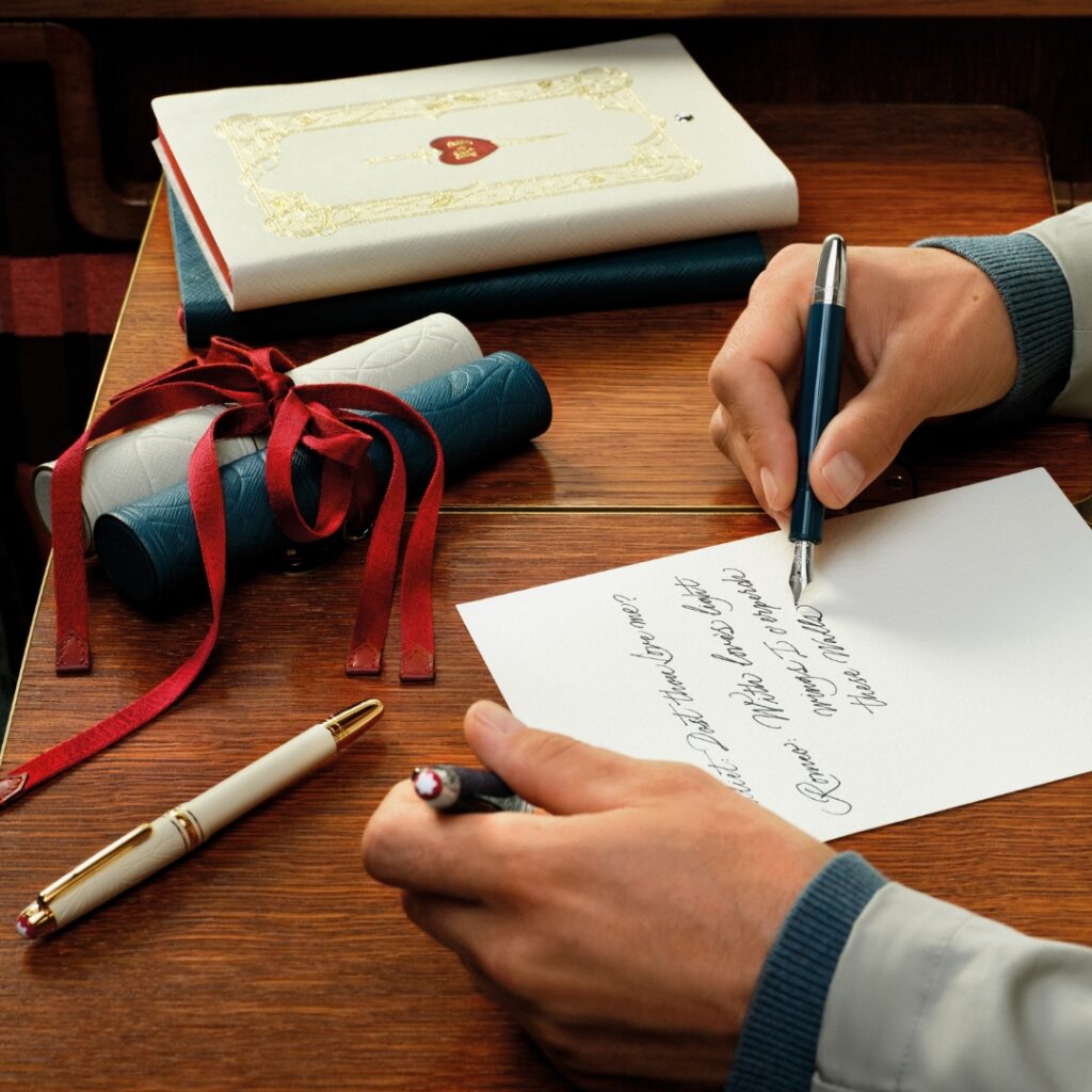 close up of a man's hand writing a letter using a ink pen from the Montblanc Romeo & Juliet colletion