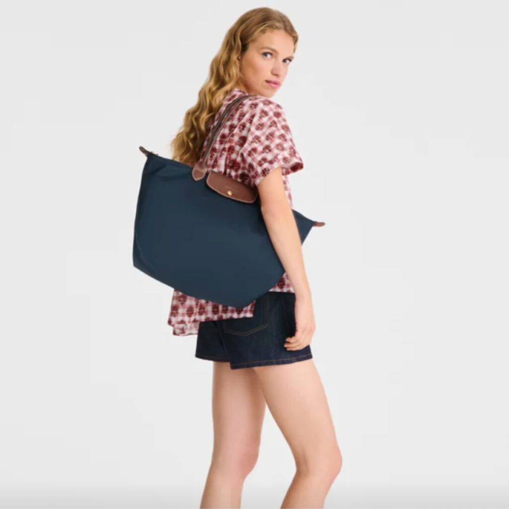 woman carrying Le Pilage, the Longchamp bag revival