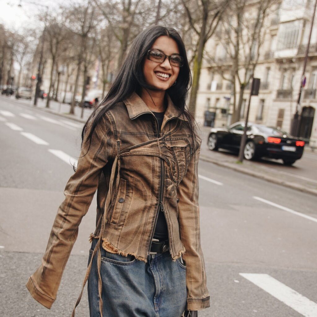 fashionista crossing the street. She is wearing a leather jacket