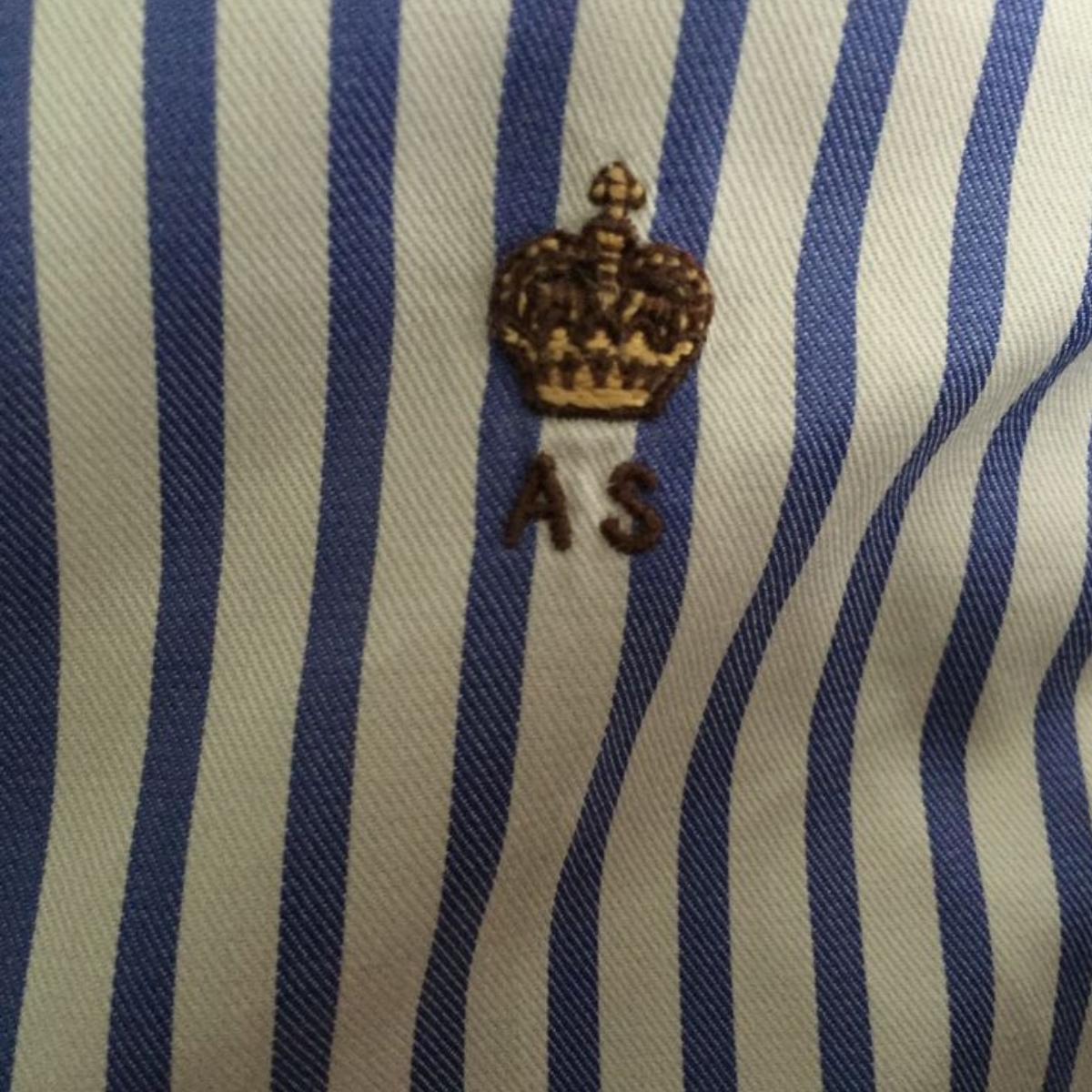 detail of a monogram on a male bespoke shirt